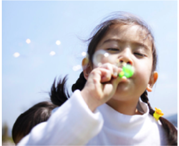 Picture of child blowing bubbles
